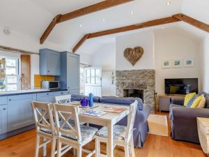 a kitchen and living room with a table and chairs at 2 Bed in Wadebridge oc-82682 in Little Petherick