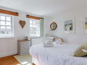 a white bedroom with two beds and a sink at 2 Bed in Wadebridge oc-82682 in Little Petherick