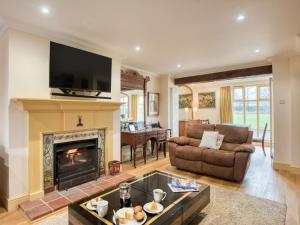 a living room with a fireplace and a tv at 5 Bed in Choseley oc-kt086 in Titchwell