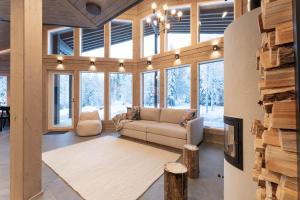 a living room with a couch and some windows at Villa Vaellus in Ruka