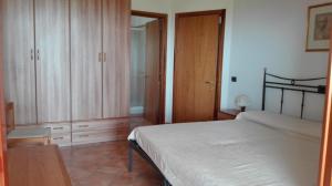 a bedroom with a bed and wooden cabinets and a table at Villa Chiara in Bracciano