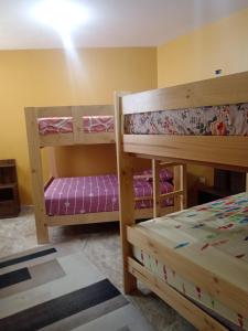 a room with two bunk beds and a bed at La Casa Del Hombre in Puerto Chicama +21 photos