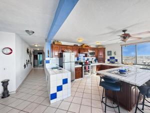 a kitchen with blue and white tiles on the floor at Penthouse Water View in Puerto Peñasco