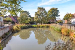 a river in a town with trees and houses at 2 Bed in Ashley oc-c32637 in Ashley