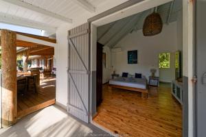 an open door leading to a living room with a bed at Makiese Resort in Saint-François +68 photos