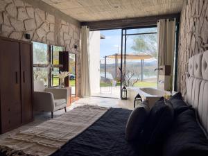 a bedroom with a bed and a large window at Dos Aguas Hotel Boutique in Encinillas +120 photos