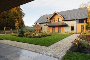 a house with a garden in front of it at Apartamenty Greenwood in Staniszów