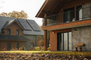 a house with solar panels on the roof at Apartamenty Greenwood in Staniszów