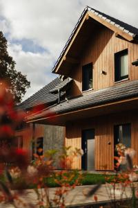 a wooden house with a roof at Apartamenty Greenwood in Staniszów +4 photos