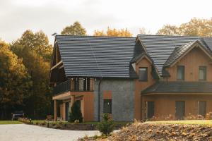 a house with a black roof at Apartamenty Greenwood in Staniszów