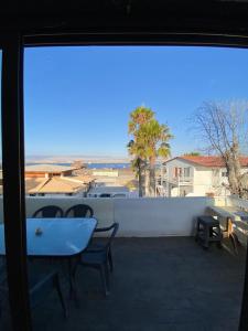 a view of a balcony with a table and chairs at Hotel & Cabañas El Mirador Caldera in Caldera