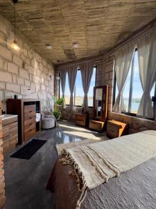 a bedroom with a large bed and some windows at Dos Aguas Hotel Boutique in Encinillas
