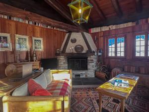 a living room with a couch and a fireplace at Chalet Le Zirizui - Authentique refuge alpin avec vue imprenable in Liddes +41 photos