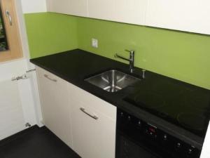a kitchen with a sink and a black counter top at Apartment Nicole 1 by Interhome in Blatten bei Naters