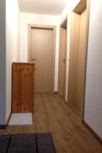 a hallway with a door and a room with wooden floors at Apartment Nicole 1 by Interhome in Blatten bei Naters
