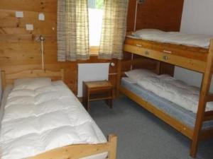a bedroom with two bunk beds and a window at Apartment Nicole 1 by Interhome in Blatten bei Naters