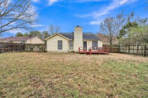 a house in a yard with a fence at Uptown Serenity in North Little Rock