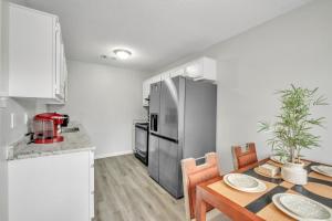 a kitchen with a dining table and a refrigerator at Uptown Serenity in North Little Rock +7 photos