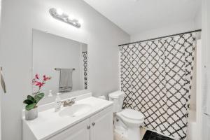 a bathroom with a sink and a toilet and a shower at Uptown Serenity in North Little Rock