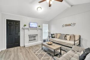 a living room with a couch and a fireplace at Uptown Serenity in North Little Rock