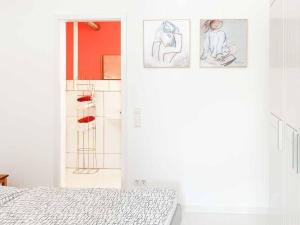 a bedroom with a bed and drawings on the wall at Apartment Perle-Lollipop by Interhome in Bullay