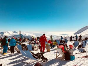 a group of people sitting in chairs in the snow at Palazzo Piccolo in Cave del Predil