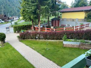 a garden with a walkway and a fence at Apartment Appartement Wasserfall by Interhome in Stall
