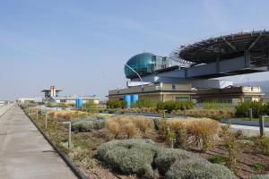 a building with a walkway and plants in front of it at Casa Torino Lingotto centro fiere, metro, Inalpi Arena,Centro Congressi, Ospedale Molinette, Politecnico in Turin
