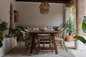a wooden table with chairs and a bowl of fruit on it at Agroturismo Son Boronat in Calvià