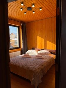 a bedroom with a bed with two pillows on it at Fangorn in Lazeshchyna