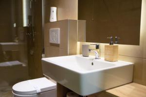 a bathroom with a white sink and a toilet at Olivia Rooms in Belgrade +39 photos
