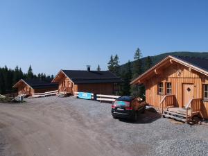 a group of cottages with a car parked in front at Holiday Home Jagdhütte by Interhome in Lachtal