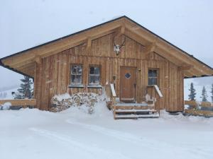 a log cabin in the snow with snow at Holiday Home Jagdhütte by Interhome in Lachtal