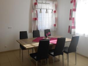 a dining room with a wooden table and chairs at Apartment Wohnung Michaela in Flattach by Interhome in Flattach