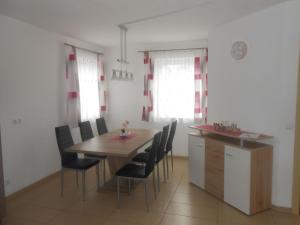 a dining room with a wooden table and chairs at Apartment Wohnung Michaela in Flattach by Interhome in Flattach