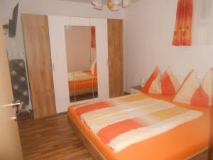 a bedroom with a large bed with an orange mattress at Apartment Wohnung Michaela in Flattach by Interhome in Flattach