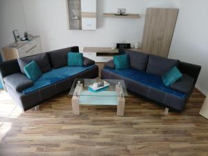 a living room with two couches and a coffee table at Apartment Wohnung Michaela in Flattach by Interhome in Flattach +17 photos
