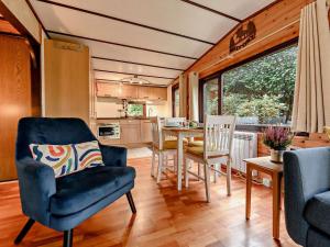 a living room with a table and chairs and a kitchen at 2 Bed in Ambleside oc-75731 in Grasmere +11 photos