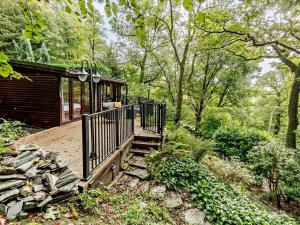 a cabin in the woods with a wooden deck at 2 Bed in Ambleside oc-75731 in Grasmere