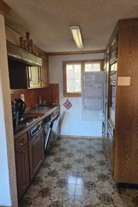 a kitchen with a sink and a stove top oven at Apartment Châlet Hochmatt by Interhome in Im Fang