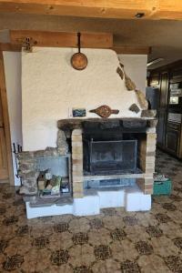 a living room with a stone fireplace in a room at Apartment Châlet Hochmatt by Interhome in Im Fang