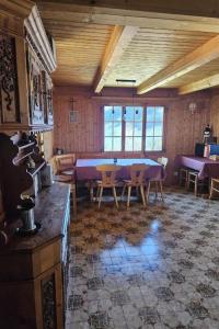 a large room with a table and chairs in it at Apartment Châlet Hochmatt by Interhome in Im Fang +3 photos