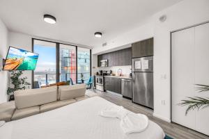 a living room with a couch and a kitchen at Bay Views Studio in Miami