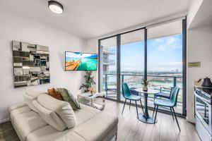 a living room with a couch and a table with chairs at Bay Views Studio in Miami