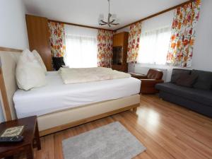 a bedroom with a bed and a living room at Apartment Erna Angermaier by Interhome in Flattach