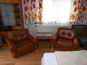 a living room with two chairs and a couch at Apartment Erna Angermaier by Interhome in Flattach