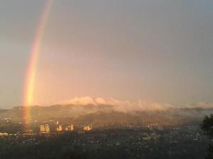 a rainbow in the sky over a city at Apartment Gurtendörfli by Interhome in Wabern