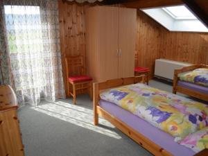 a bedroom with two beds and a window at Apartment Wohnung Rustique by Interhome in Chevenez