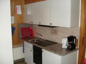 a kitchen with a sink and a counter top at Apartment Wohnung Rustique by Interhome in Chevenez