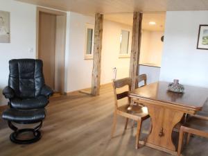 a living room with a table and a chair at Apartment Leinacherhof by Interhome in Seeberg